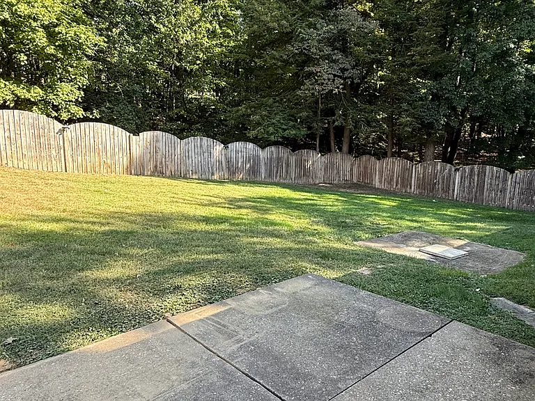 private backyard patio and fenced yard