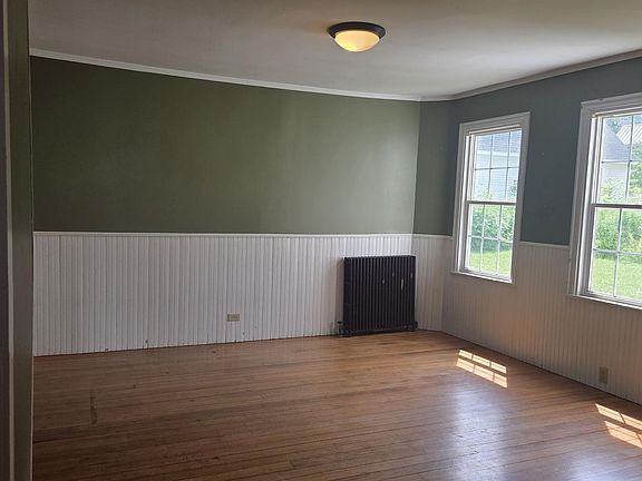 Bright, Sunny Dining Area With Lovely Hardwood Flooring, And Wainscoting.