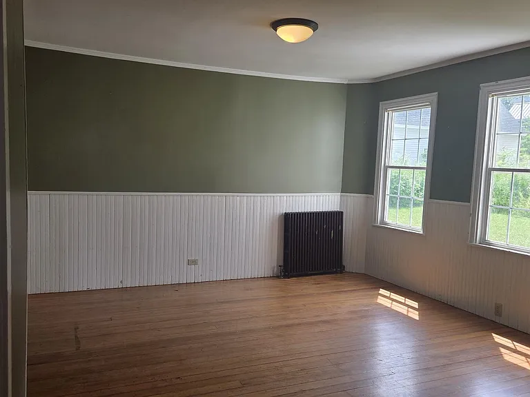 Bright, Sunny Dining Area With Lovely Hardwood Flooring, And Wainscoting.