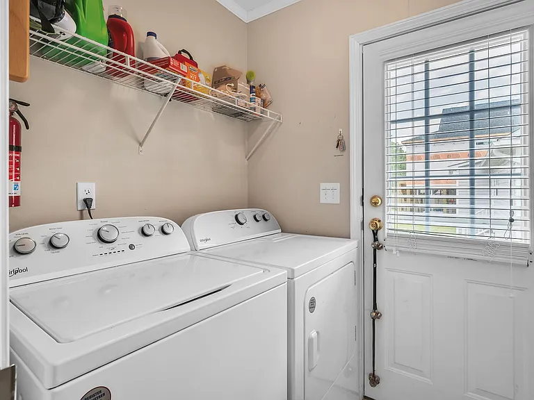 Washer and dryer purchased in 2023. Door opens to the gated back yard.