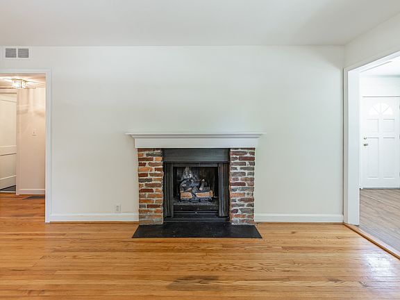 Sunroom/home office towards right of gas log fireplace;