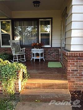 Lovely front porch area is so quaint!  You will enjoy sitting here in the shade enjoying the seasons!