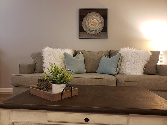 Full sized, extra deep couch or sectional fit perfectly in this large living room