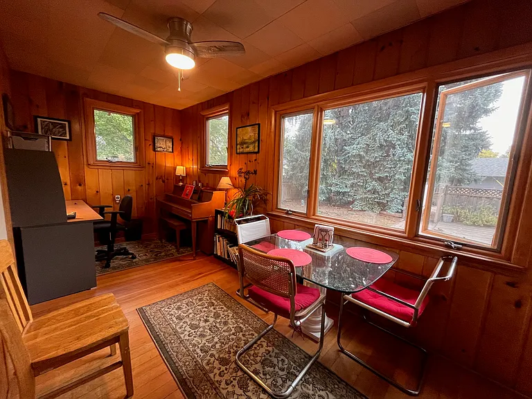 sun room with piano and breakfast table