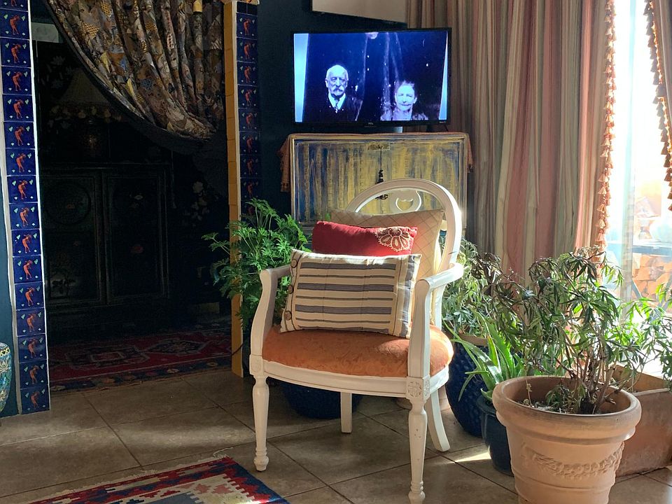 Living room with wood burning fireplace, patio with gate to side yard, entry to bedroom and full bath.