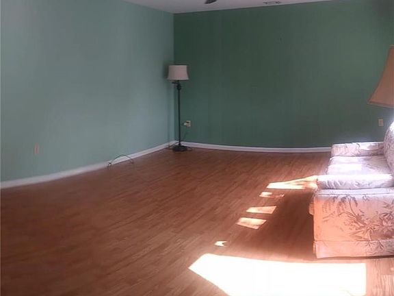 Beautiful flooring and paint in living room with lots of natural lighting.