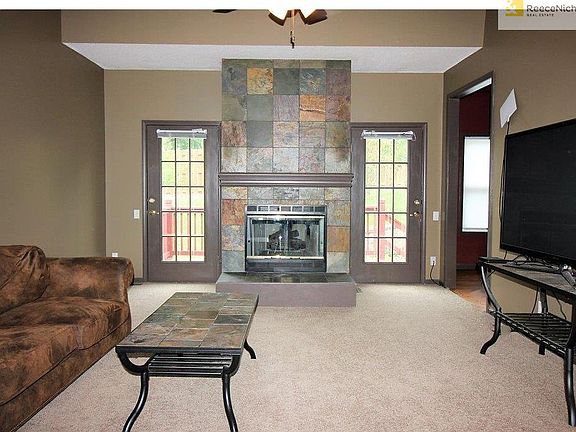 Spacious living room with beautiful fireplace and access to the back deck.