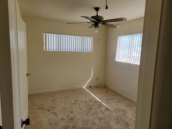 Bedroom with new carpet, paint and vertical blinds