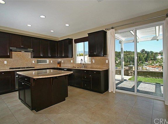 Open concept kitchen with lots of upgrades, island and breakfast bar.