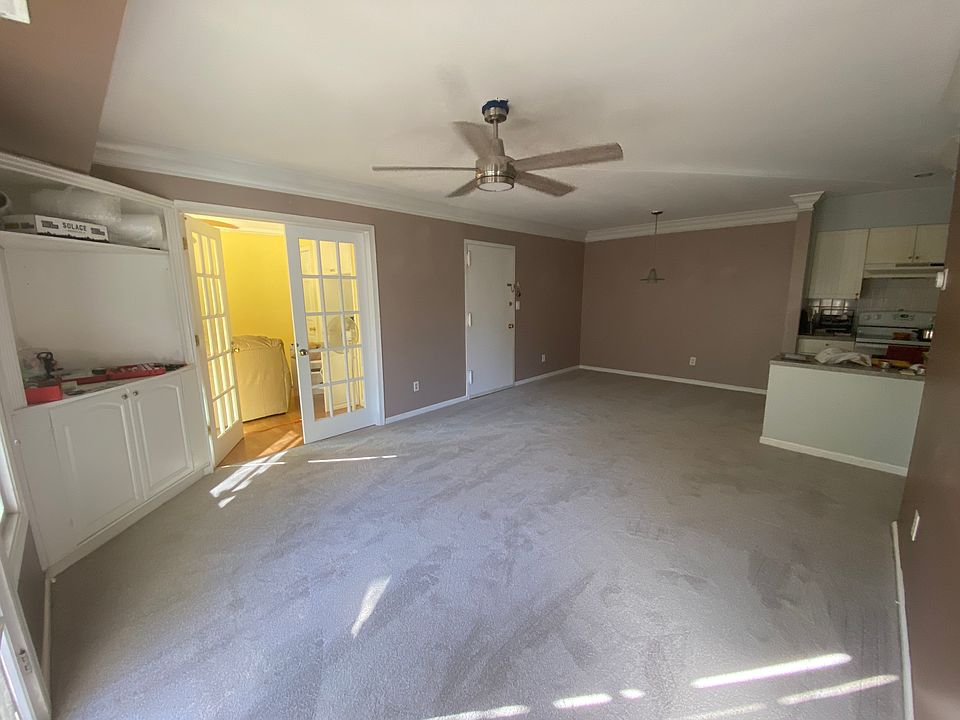 Living room + dining room with 3rd bedroom seen through the French doors