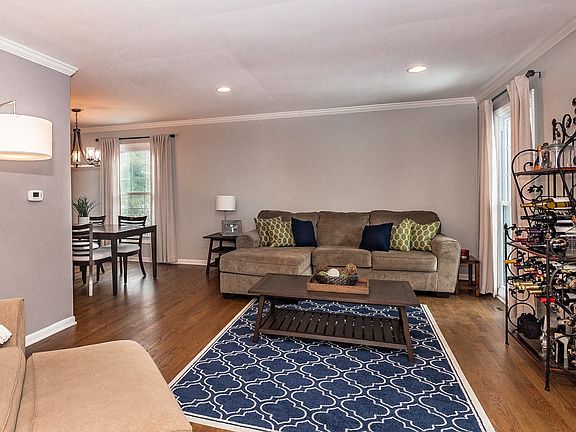 Living Room is light and brights with recessed cans, crown molding and wood floors.