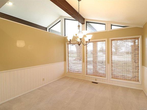Formal Dining Room is open to living room with vaulted ceilings and lots of windows for front view of home.