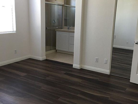 Master bedroom with high ceiling and two closets.