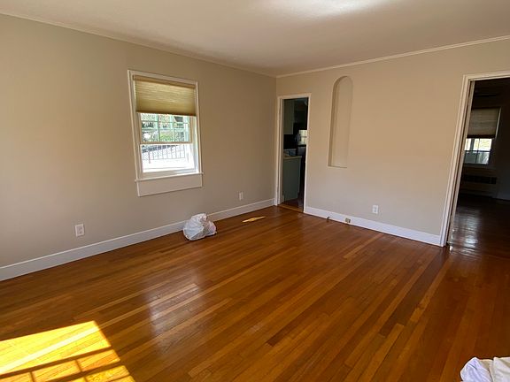 Sun filled large living room. Kitchen to the left, bedroom to the right.