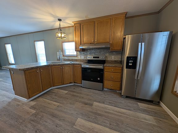 Kitchen with Peninsula, electric stove, and side by side with icemaker