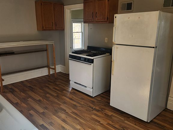 Nice open kitchen with table on the side for microwave or other small appliances. Room for a small table and chairs on right, not shown in photo