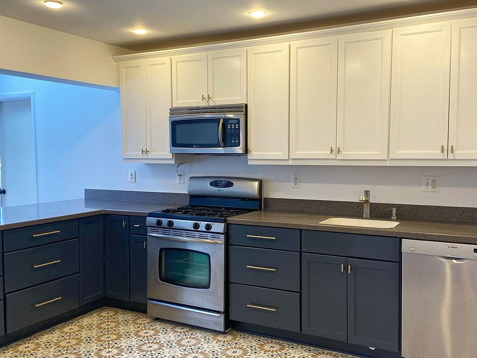 Updated two-tone kitchen with SS appliances and gold hardware