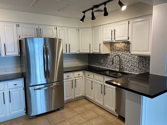 Recently renovated kitchen with bar seating addition, new lighting and brand new paint.