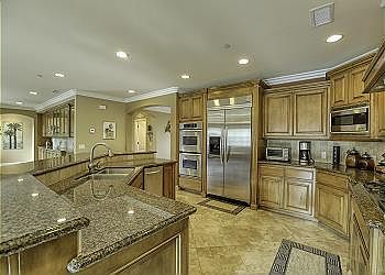 The granite kitchen island and countertops offer generous space to prepare your meals.
