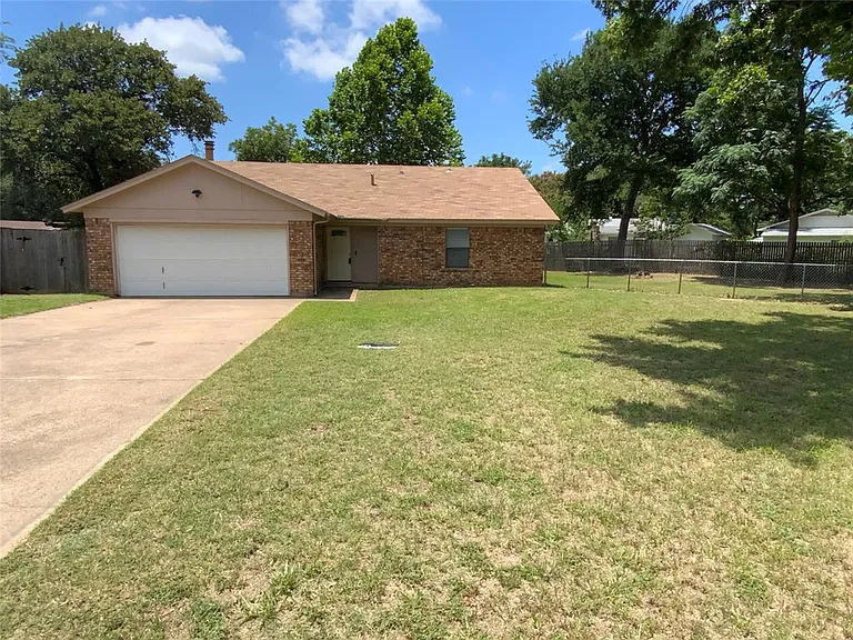 Brick exterior with a single-car garage and concrete driveway