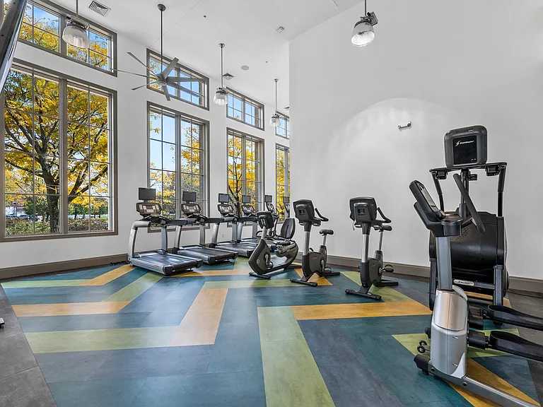 a workout room with treadmills and elliptical trainers at Harbor Pointe in Bayonne, NJ