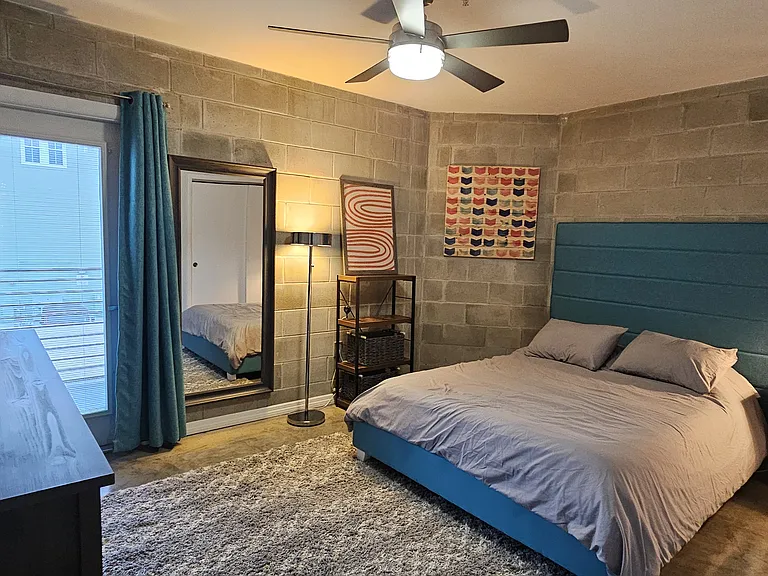 Main bedroom includes queen bed. Back door provides access to the back balcony.