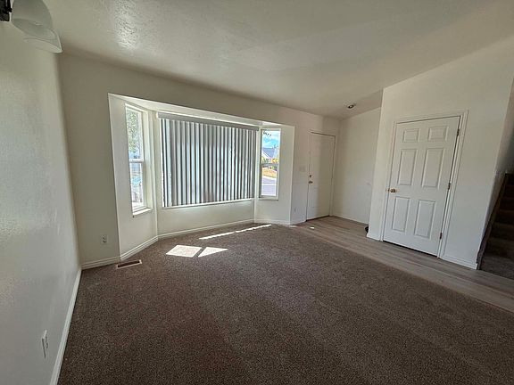Front living room and entrance with built-in coat closet. The bay window gives it an elegant touch.