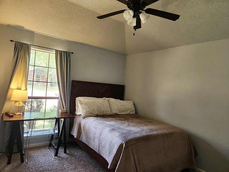 Queen bed, dresser, window view desk with chair, closet.