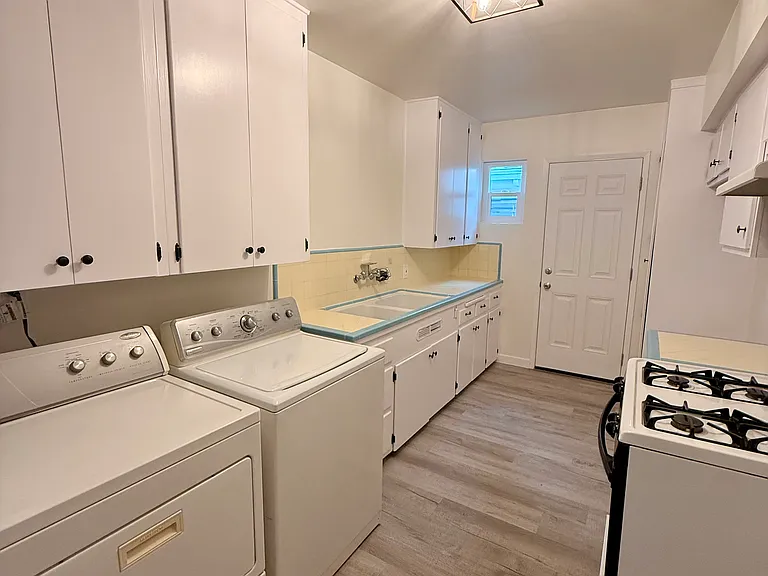 Freshly Painted Cabinets with Rubbed Bronze finish, Double Deep Sink, New Lighting Fixture, Built in Pantry, and yes- a built in Washer and Dryer!