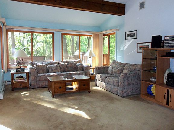 Living Room With Beamed Cathedral Ceilings