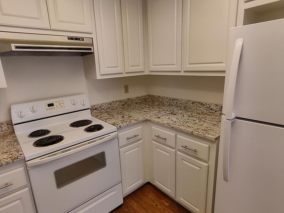 Updated kitchen with marble countertops and new cupboards.