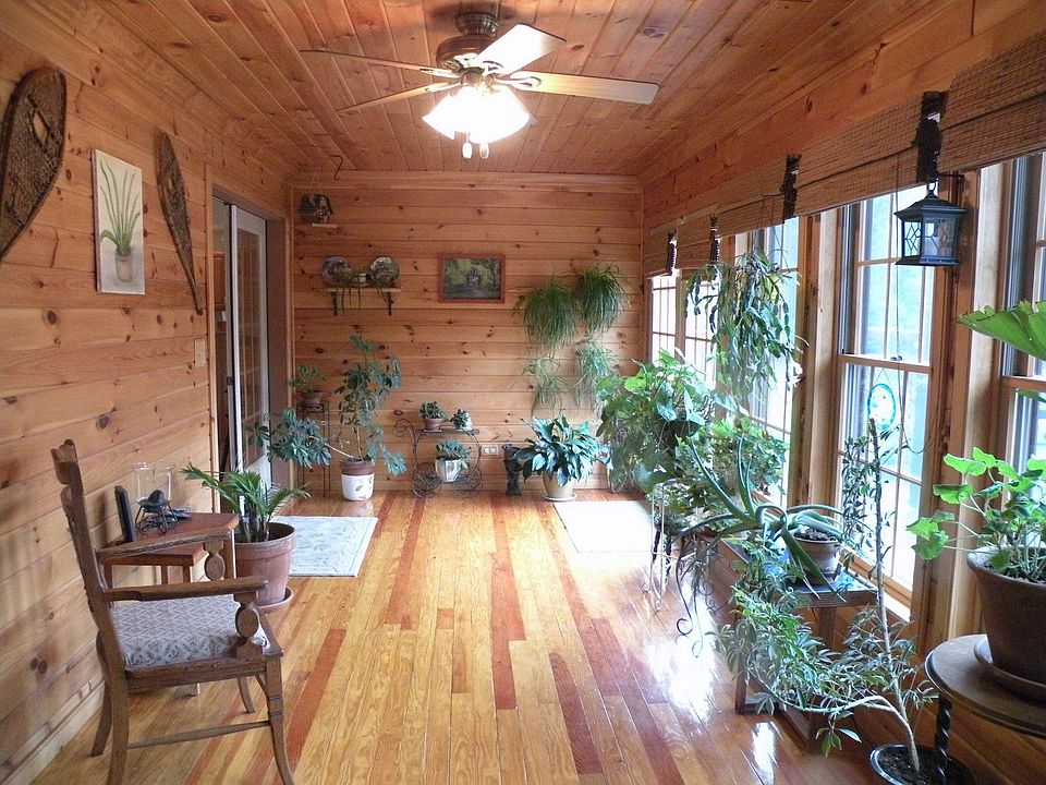 The heated sunroom looks out over the yard and heated pool.