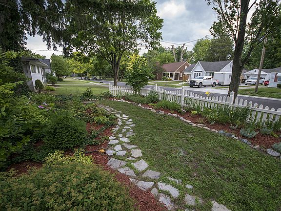 Take a look at the gorgeous landscaping with stone pathway encompassing the front yard.