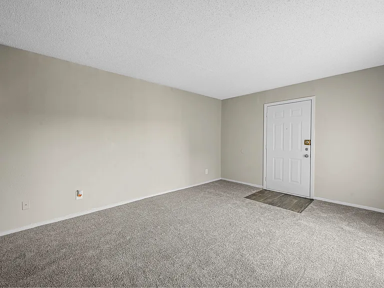 Endless possibilities living room area near entry door.