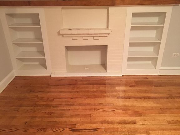 Living Room with book shelf and mantle
