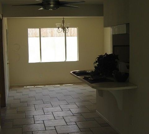 Tile continues past kitchen and eating bar, and into dining area.