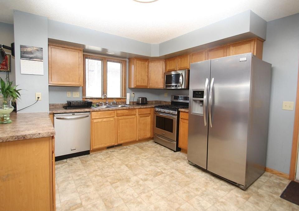 Open Concept Kitchen with Stainless appliances, and gas stove. Wilndow looks to back yard.