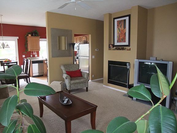 Spacious, open living room with fireplace. (New hard floors not shown, also walls are a tan color.)