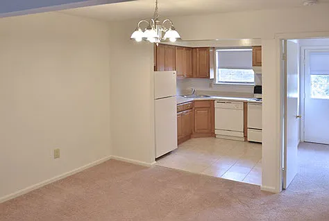 Dining Room with view into kitchen and den area.