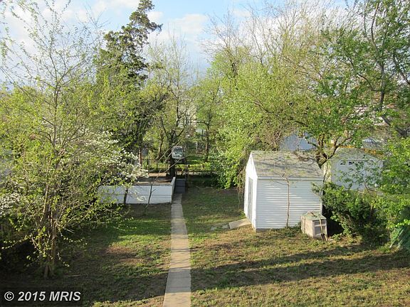 Huge rear yard with parking pad and large shed