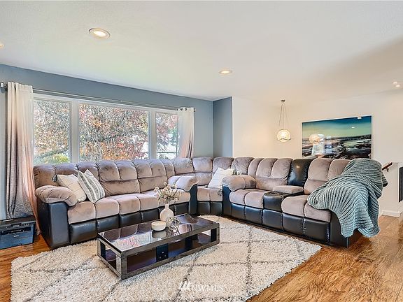 The Living room is generous and features wood look laminate floors.