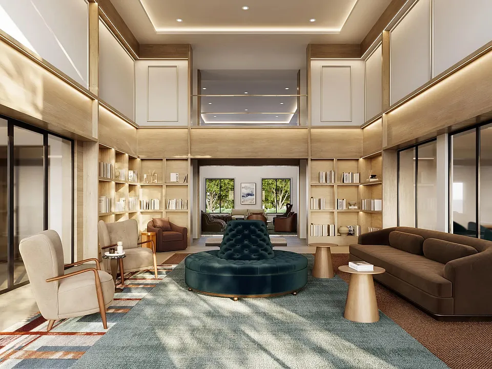 The clubroom features double-height ceilings, curated lounge seating, built-in library shelving, private meeting spaces, and sophisticated design elements that create a welcoming environment for gathering, working, and relaxing.