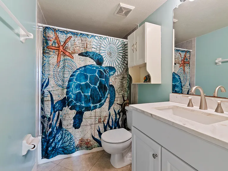 Guest en-suite bathroom with full-size tub and shower.
