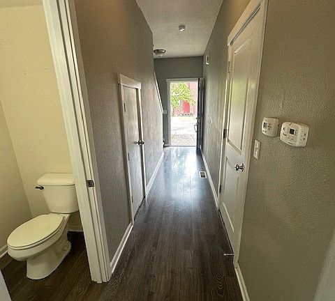 Downstairs hallway with front door open