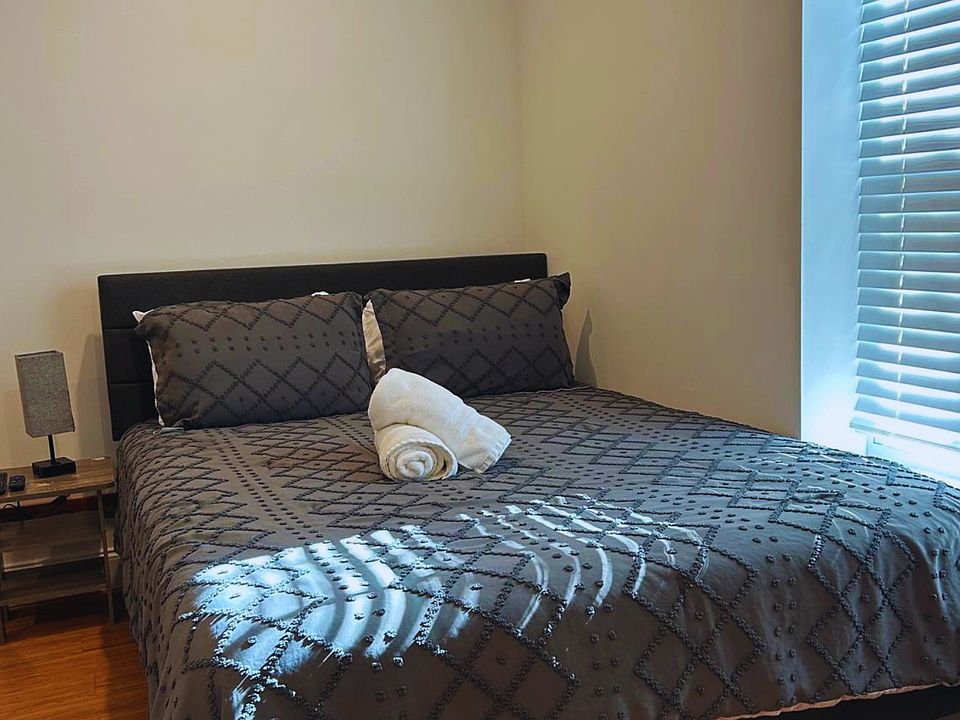 Spacious studio with a queen bed, premium linens, and plush pillows.