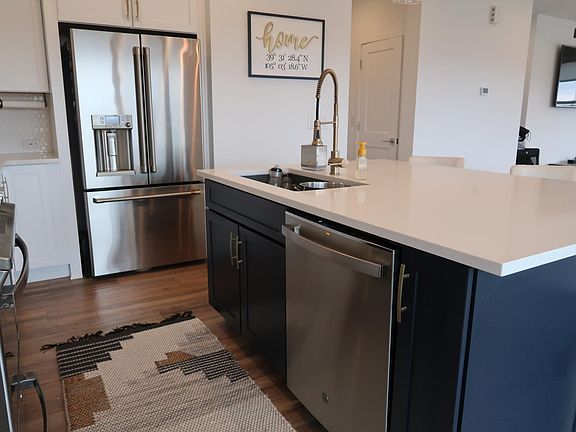 Blue Island Cabinets with Brass Hardware. Stainless steel appliances