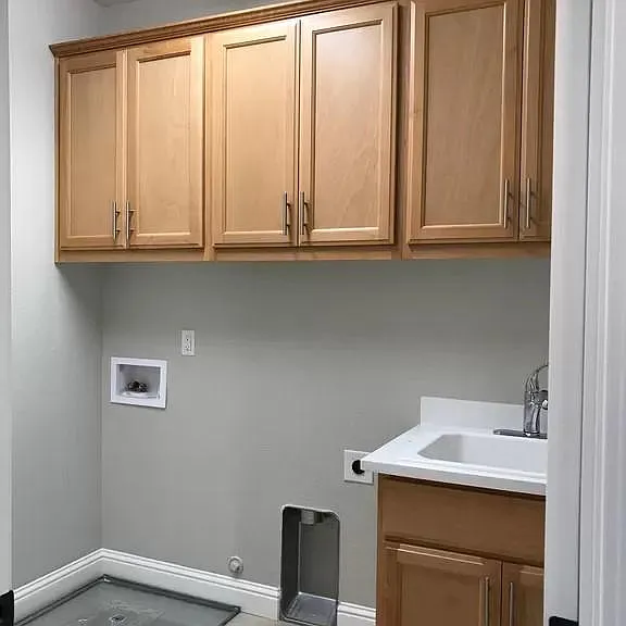 laundry room with a sink, upstairs