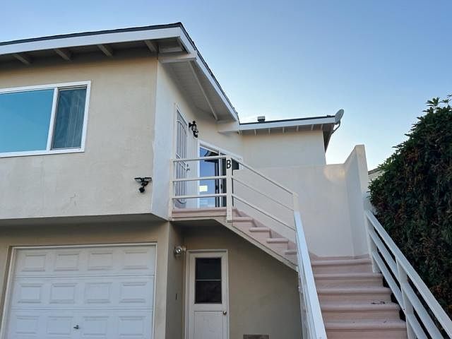 Staircase to unit above garage and laundry room