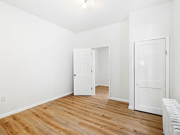 Spacious bedroom with hardwood floors.