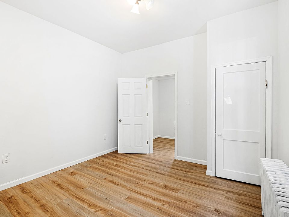 Spacious bedroom with hardwood floors.